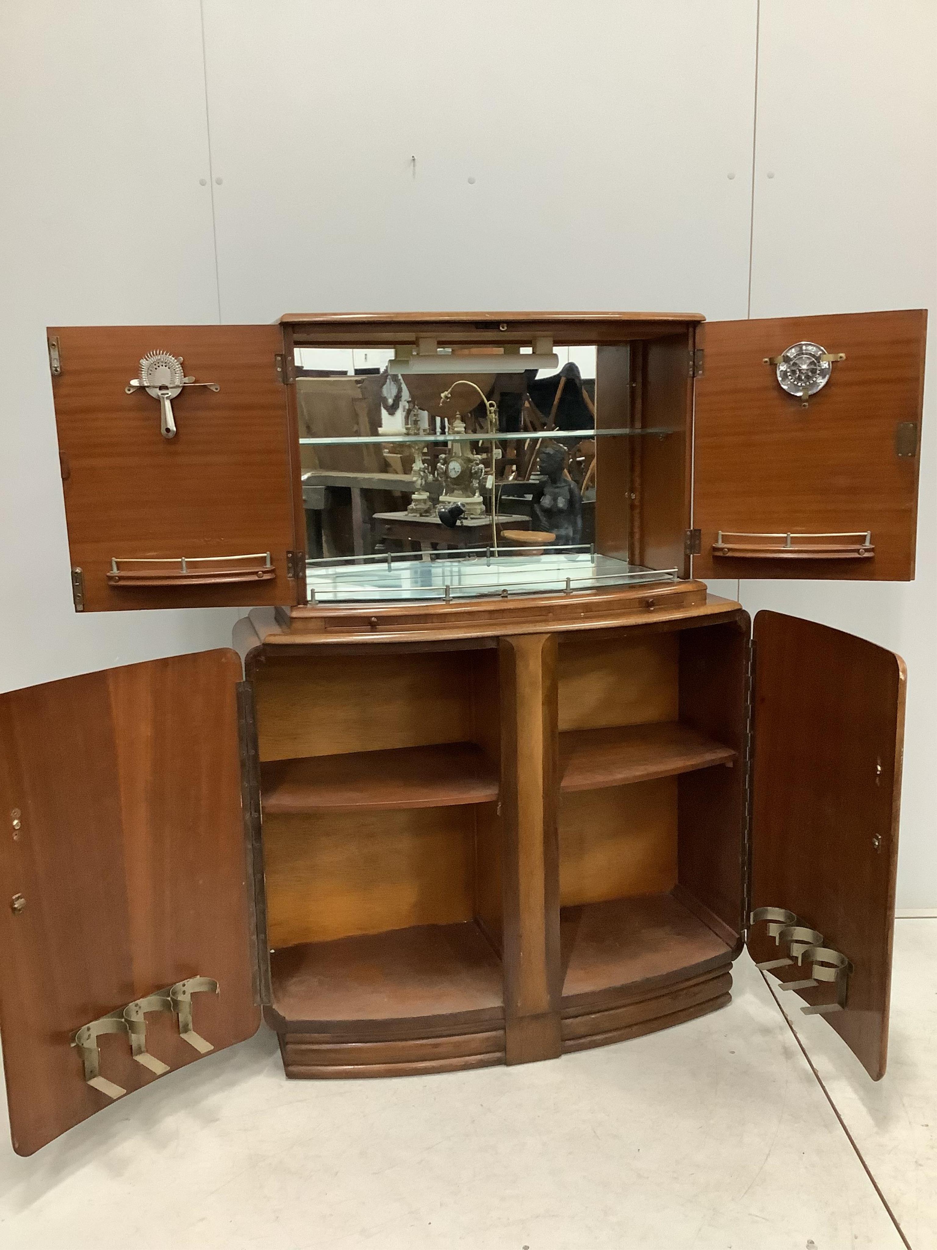 An Art Deco style walnut cocktail cabinet, width 102cm, depth 38cm, height 144cm. Condition - fair